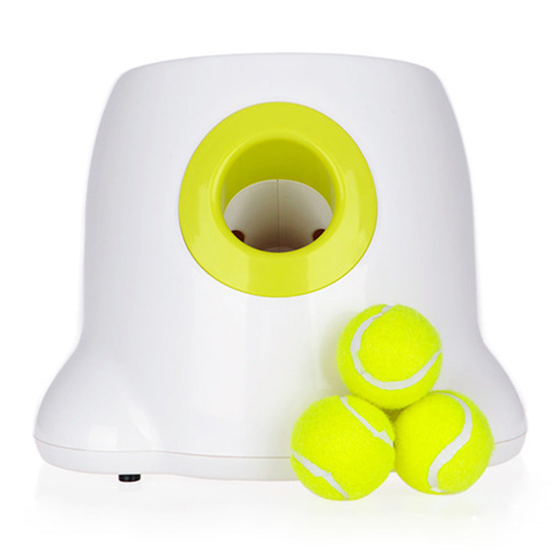 Orange Poppy automatic dog ball launcher in white with lime green mouth and three neon tennis balls