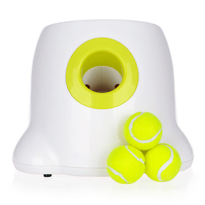 Orange Poppy automatic dog ball launcher in white with lime green mouth and three neon tennis balls