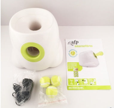 White and green automatic dog ball launcher with three tennis balls charger and instruction sheet