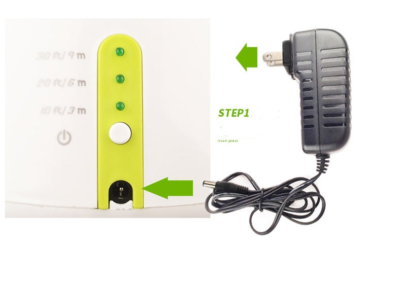 Close up of automatic dog ball launcher base showing power adapter port green LED indicators and white button