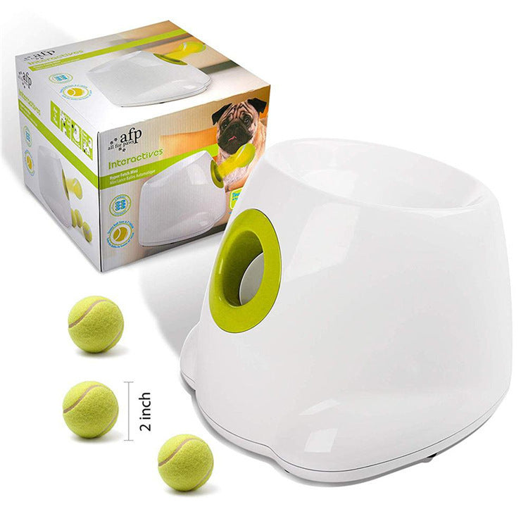 Orange Poppy automatic dog ball launcher in white with green launch port and three 2 inch tennis balls