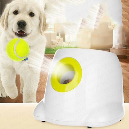 Orange Poppy automatic dog ball launcher white with yellow rim beside golden retriever puppy holding tennis ball in living room