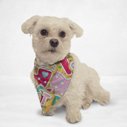 Small white dog wearing colorful Christmas pet bandana with festive heart and candy designs