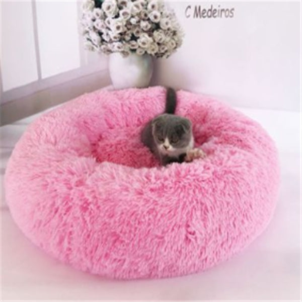 Orange Poppy pink round fluffy cat bed donut style with gray cat lounging in center by window