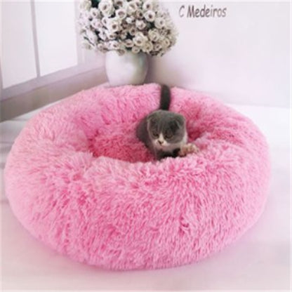 Orange Poppy pink round fluffy cat bed donut style with gray cat lounging in center by window