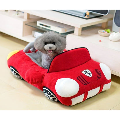 Orange Poppy dog bed shaped like a car red plush convertible pet bed with cushioned sides and small gray poodle inside