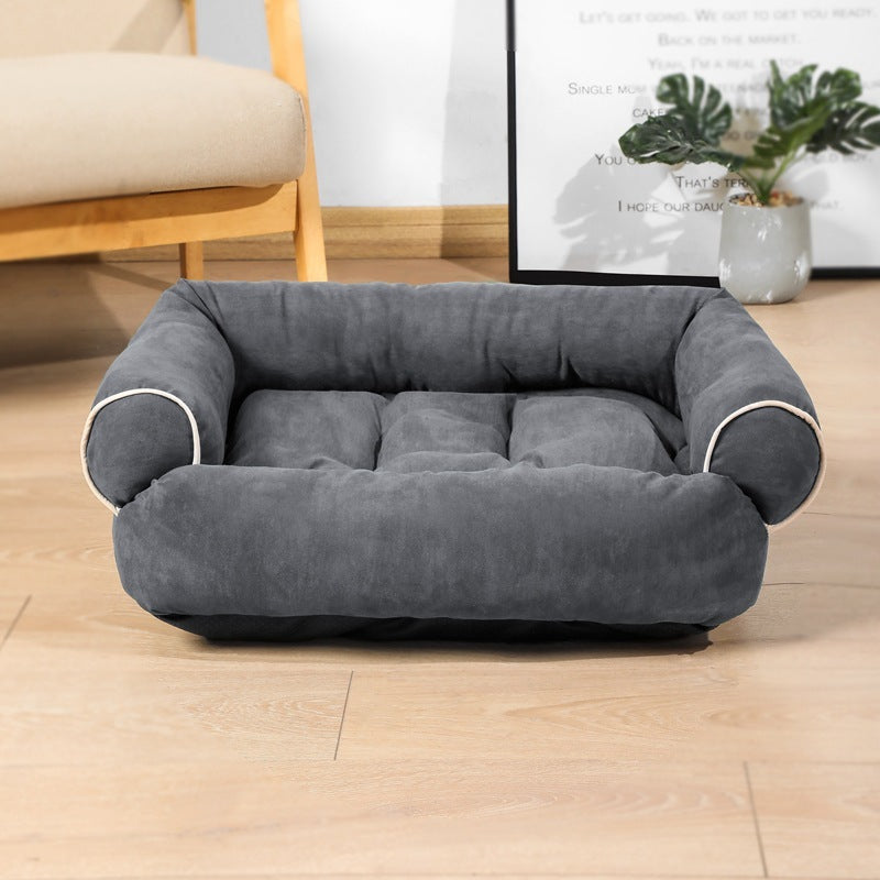 Orange Poppy warm cat and dog cushion plush gray bolster bed with raised sides and tufted center on hardwood floor