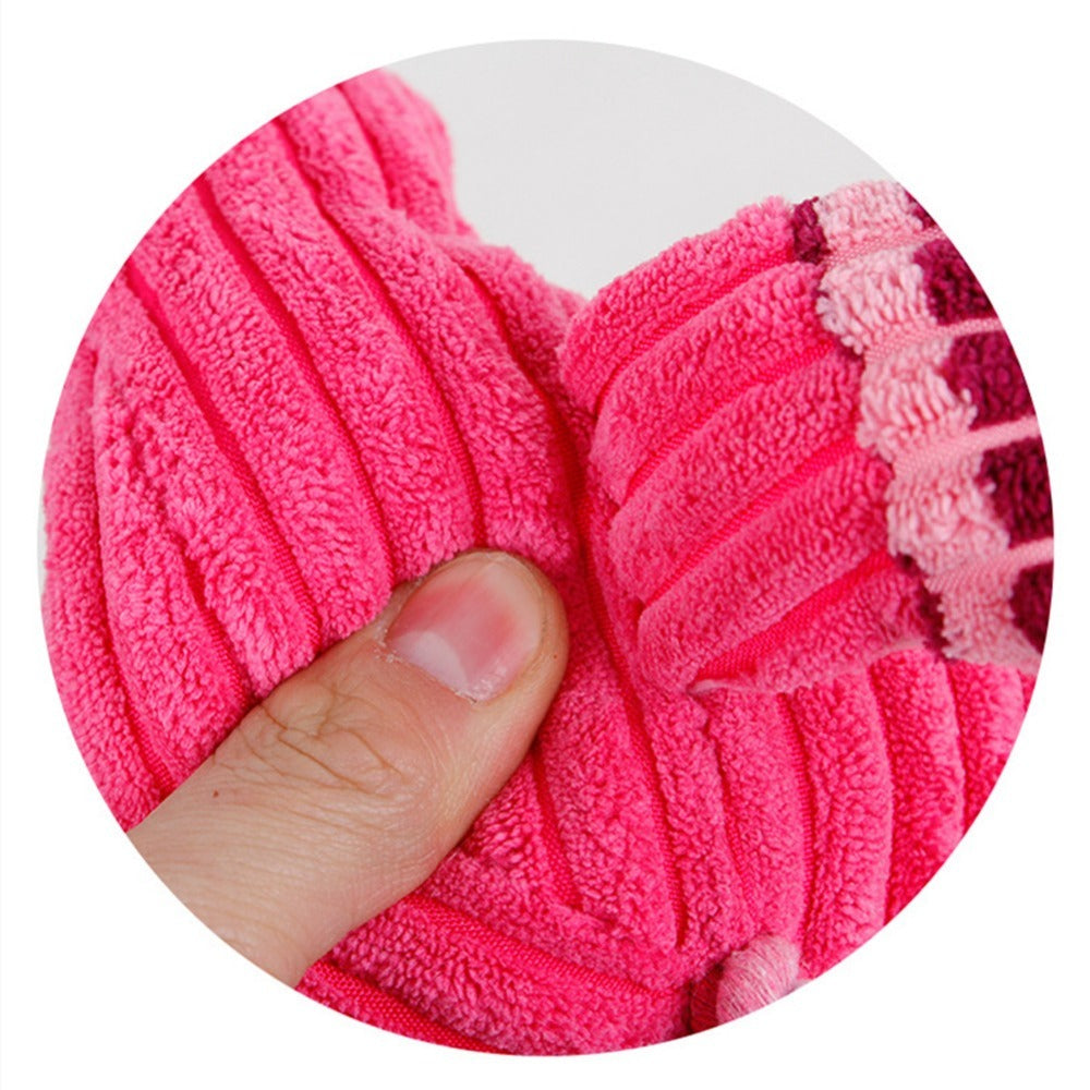 Bright pink dog teeth cleaning plush toy designed for effective dental care and fun playtime