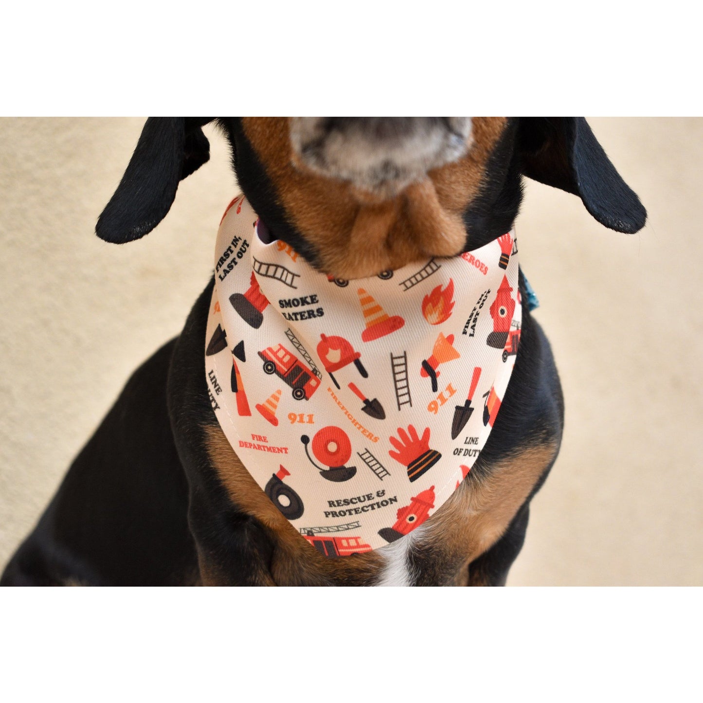 Dog wearing a firefighter dog bandana with fire truck and safety icons by Scarlet Gaia