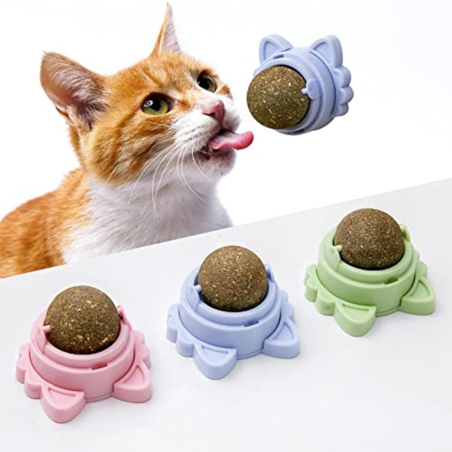 Orange tabby cat licking treat ball in pastel silicone holders set healthy cat teeth cleaning toy