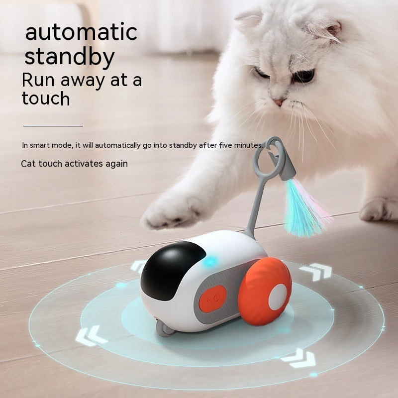 Orange Poppy remote control cat toy with wheeled body and LED feather tail being pawed by white longhair cat on hardwood floor