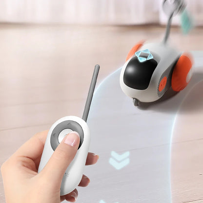 Orange Poppy remote control cat toy with wireless handheld remote and rolling orange wheeled robot on hardwood floor