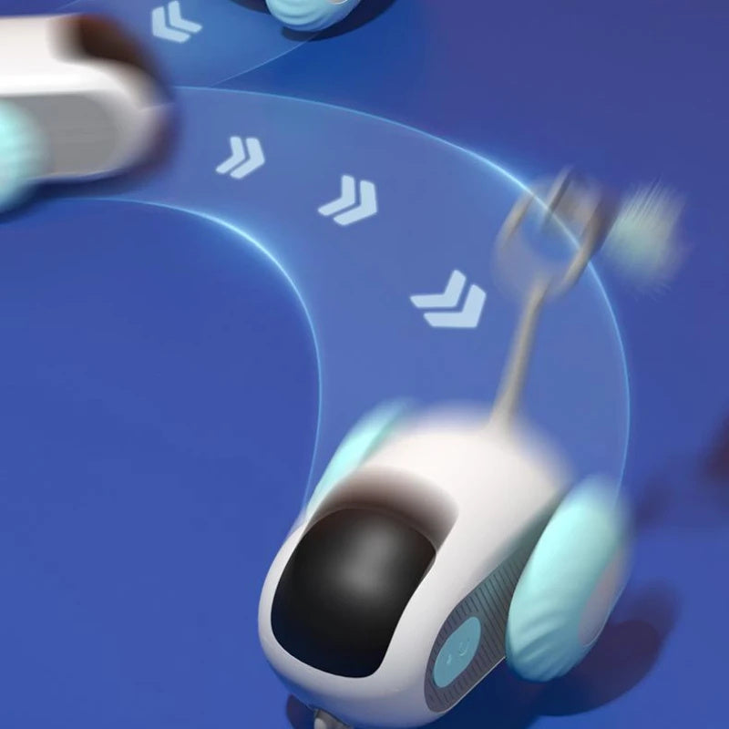 Orange Poppy remote control cat toy white and aqua rolling pet robot with motion trails on blue play mat for indoor cats