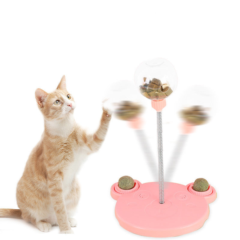Orange Poppy interactive cat feeder toy pink paw base with wobbling treat dispenser and curious tabby cat