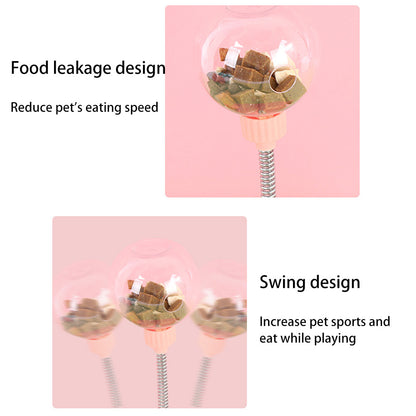 Orange Poppy interactive cat feeder toy with clear food ball on spring pole slowing eating and swinging play