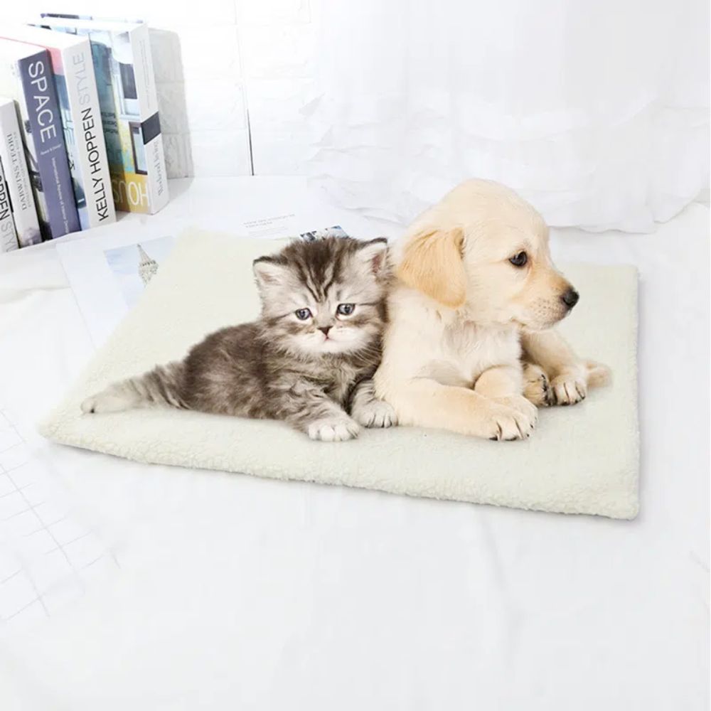 Yellow Pandora self warming pet mat with a kitten and puppy lying comfortably on a soft white bed