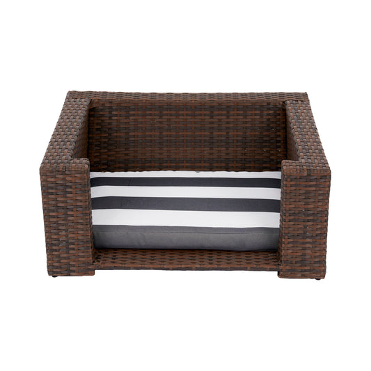 Ochre Menoetius rattan dog bed with cushion featuring dark brown woven frame and black white striped cushion
