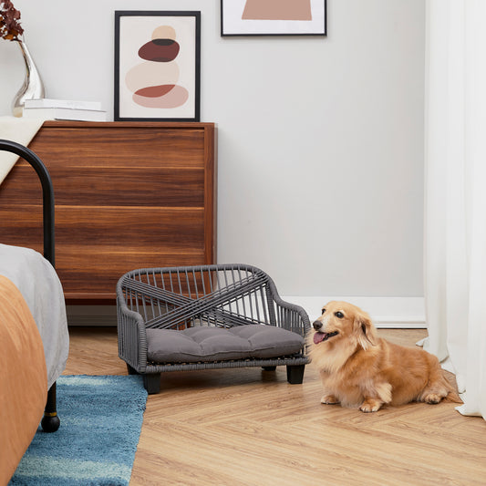 Ochre Menoetius woven rope pet bed in gray with cushion next to a small dog on a wood floor